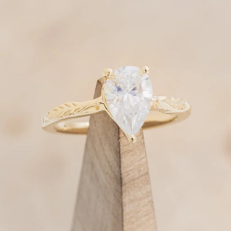 "HOPE" - PEAR CUT MOISSANITE SOLITAIRE ENGAGEMENT RING WITH FEATHER ACCENTS